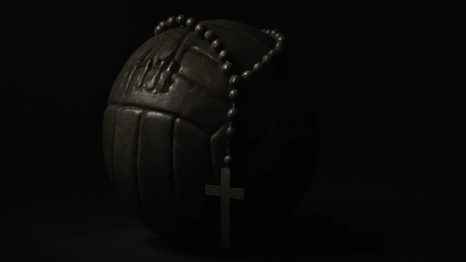 A wooden rosary draped over a weathered leather football in darkness, lit by a single shaft of light.